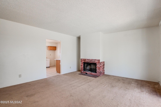 9552 E Irene St, Tucson, AZ 85730 - unfurnished living room with light colored carpet, a brick fireplace, and a textured ceiling