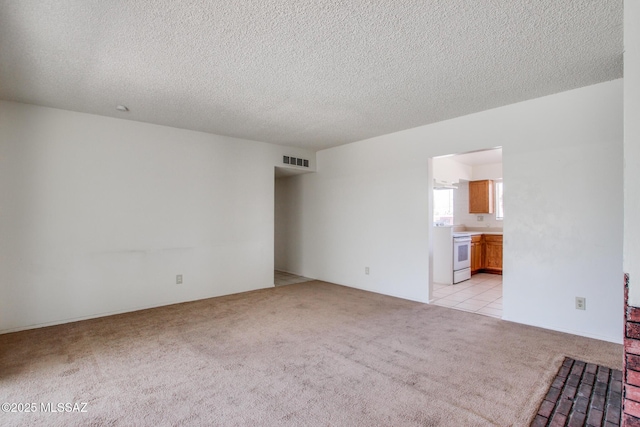 9552 E Irene St, Tucson, AZ 85730 - unfurnished room featuring light colored carpet and a textured ceiling