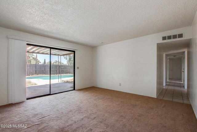 9552 E Irene St, Tucson, AZ 85730 - spare room with carpet and a textured ceiling