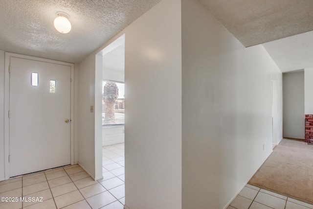 9552 E Irene St, Tucson, AZ 85730 - entryway with a textured ceiling, light tile patterned flooring, and light carpet