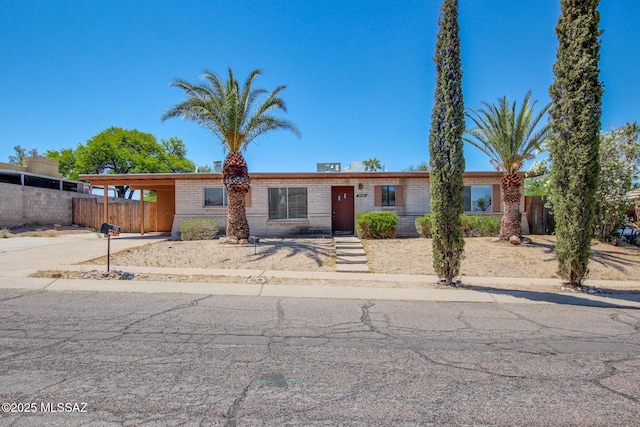9552 E Irene St, Tucson, AZ 85730 - ranch-style house featuring brick siding, driveway, and an attached carport