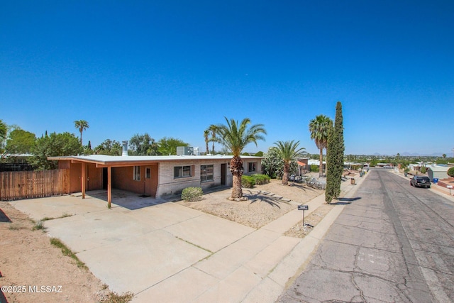9552 E Irene St, Tucson, AZ 85730 - ranch-style house with driveway, a carport, and brick siding