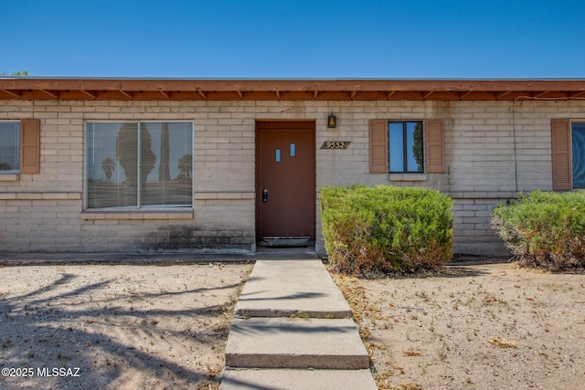 9552 E Irene St, Tucson, AZ 85730 - doorway to property featuring brick siding