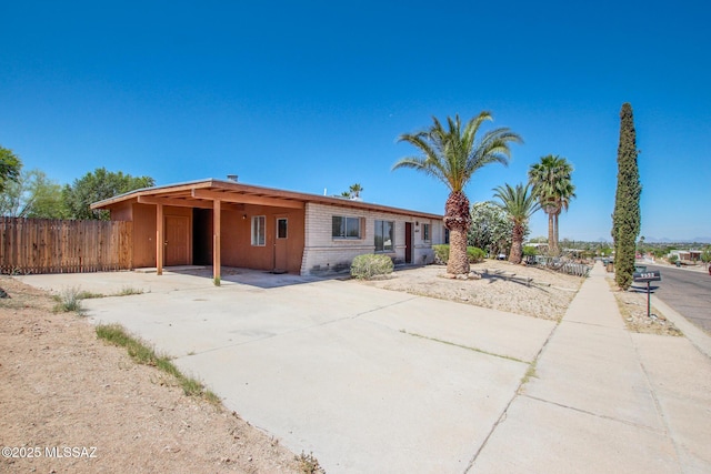 9552 E Irene St, Tucson, AZ 85730 - view of front of house with an attached carport, driveway, and brick siding