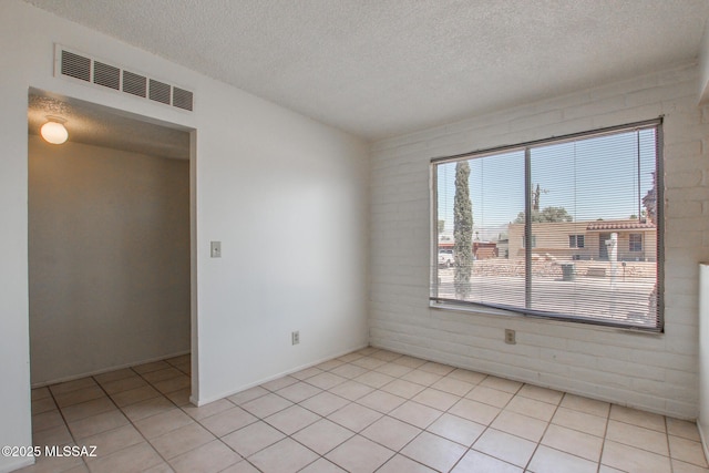 9552 E Irene St, Tucson, AZ 85730 - spare room featuring a textured ceiling and light tile patterned floors