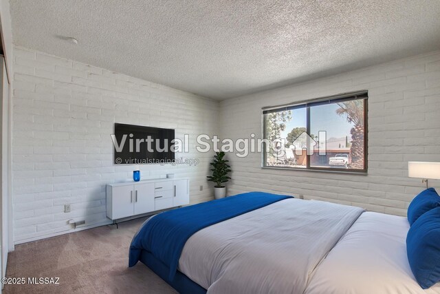 9552 E Irene St, Tucson, AZ 85730 - bedroom featuring a textured ceiling, carpet, and brick wall