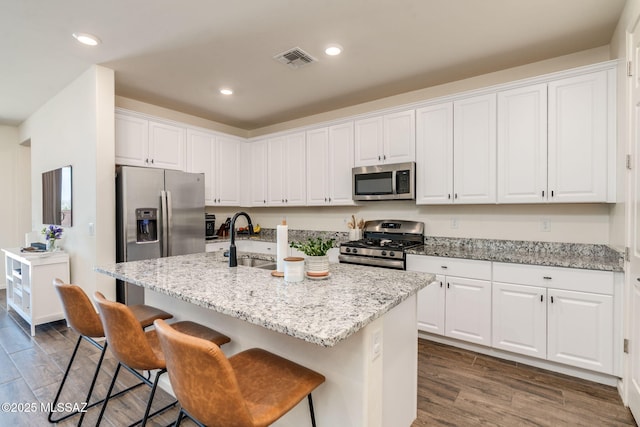 3287 W Sunlit Peak Dr, Tucson, AZ 85742 - kitchen featuring stainless steel appliances, a sink, dark wood finished floors, white cabinetry, and recessed lighting
