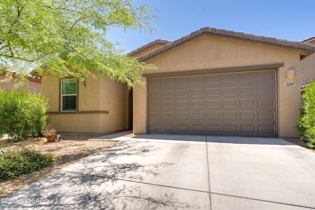 3287 W Sunlit Peak Dr, Tucson, AZ 85742 - view of front of home featuring driveway, a garage, stucco siding, and a tile roof