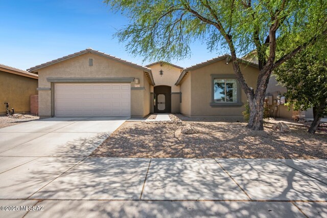 9225 S Summer Breeze Ln, Tucson, AZ 85756 - view of front of property featuring stucco siding, concrete driveway, a garage, and a tile roof