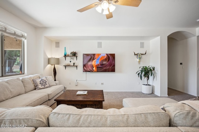 9225 S Summer Breeze Ln, Tucson, AZ 85756 - living area featuring carpet floors, a ceiling fan, arched walkways, and baseboards