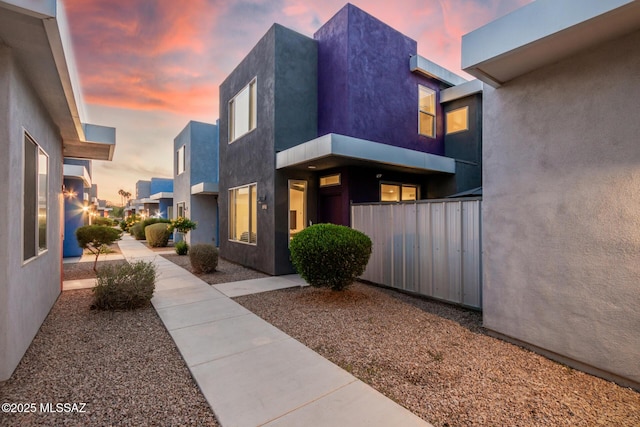 890 E Millenium Ct Unit E, Tucson, AZ 85719 - property exterior at dusk with stucco siding