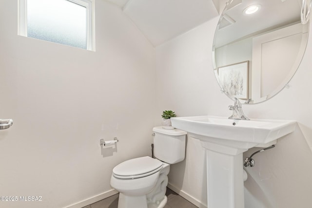 890 E Millenium Ct Unit E, Tucson, AZ 85719 - half bathroom featuring toilet, tile patterned floors, baseboards, and lofted ceiling