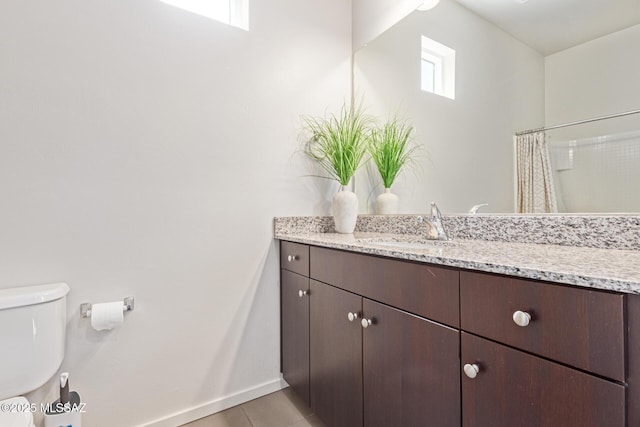 890 E Millenium Ct Unit E, Tucson, AZ 85719 - bathroom with vanity, toilet, baseboards, a shower with shower curtain, and tile patterned floors