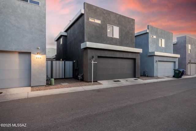 890 E Millenium Ct Unit E, Tucson, AZ 85719 - contemporary house featuring a garage and stucco siding