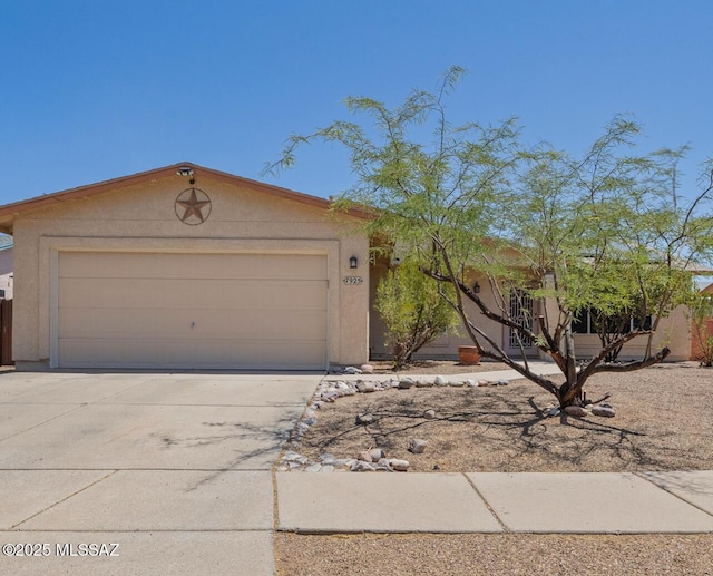 7925 S Danforth Ave, Tucson, AZ 85747 - view of front of property with driveway, a garage, and stucco siding