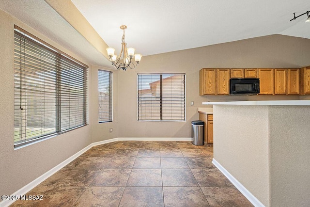 7925 S Danforth Ave, Tucson, AZ 85747 - kitchen with black microwave, lofted ceiling, a chandelier, baseboards, and hanging light fixtures