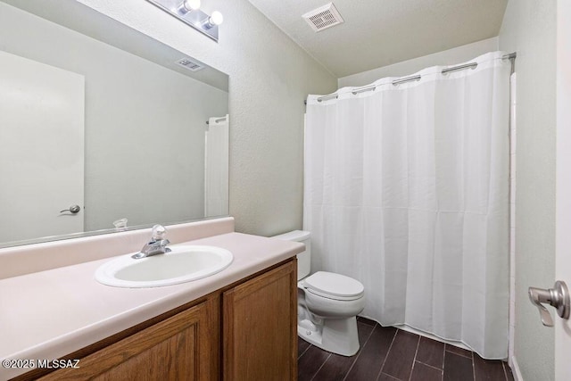 7925 S Danforth Ave, Tucson, AZ 85747 - full bath featuring wood finish floors, vanity, toilet, and a shower with curtain