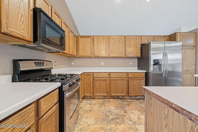 7925 S Danforth Ave, Tucson, AZ 85747 - kitchen featuring appliances with stainless steel finishes, light countertops, light stone finish floors, and lofted ceiling