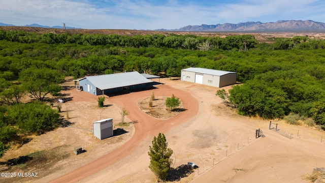 577 W Whitney Ln, Saint David, AZ 85630 - aerial view of property and surrounding area featuring a heavily wooded area and a mountainous background
