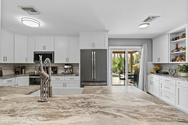 9000 N Twain St, Tucson, AZ 85742 - kitchen featuring stainless steel appliances, open shelves, decorative backsplash, white cabinetry, and light stone countertops