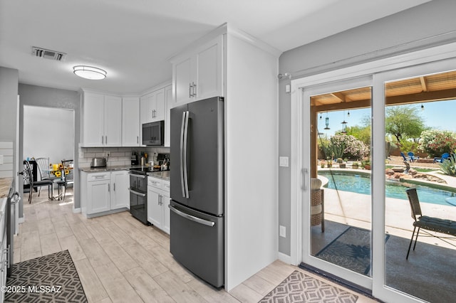 9000 N Twain St, Tucson, AZ 85742 - kitchen featuring black appliances, light stone countertops, white cabinetry, and light wood finished floors