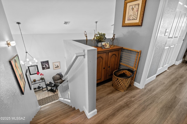 9000 N Twain St, Tucson, AZ 85742 - hallway with wood finished floors, a chandelier, and baseboards
