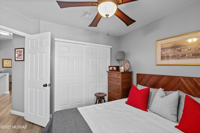 9000 N Twain St, Tucson, AZ 85742 - bedroom featuring a closet, wood finished floors, ceiling fan, and baseboards