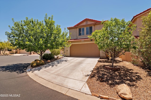 9000 N Twain St, Tucson, AZ 85742 - view of front of property featuring a tile roof, stucco siding, an attached garage, and concrete driveway