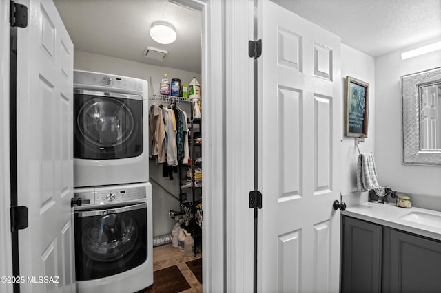 9000 N Twain St, Tucson, AZ 85742 - laundry area featuring stacked washer and clothes dryer and a textured ceiling
