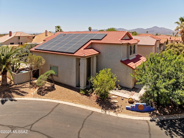 9000 N Twain St, Tucson, AZ 85742 - mediterranean / spanish-style home with stucco siding, solar panels, a tiled roof, and a mountain view