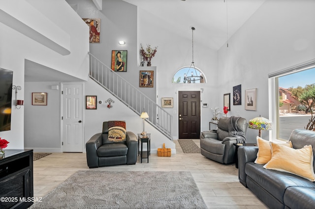 9000 N Twain St, Tucson, AZ 85742 - living area with high vaulted ceiling, stairway, a chandelier, wood finished floors, and baseboards