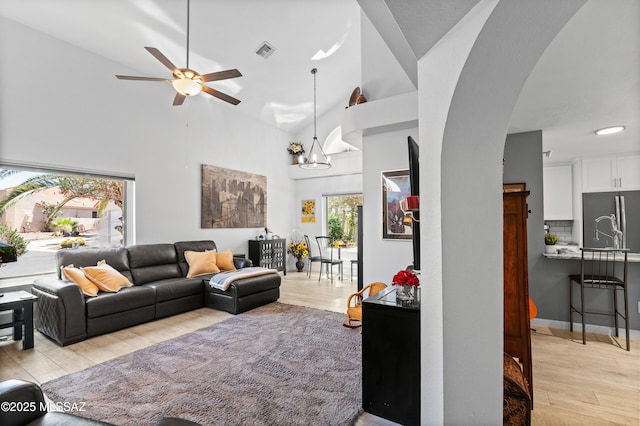 9000 N Twain St, Tucson, AZ 85742 - living area with light wood-type flooring, a ceiling fan, arched walkways, and a towering ceiling