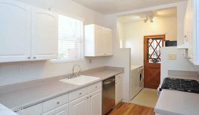 2422 E Drachman St, Tucson, AZ 85719 - kitchen featuring separate washer and dryer, stainless steel appliances, a sink, light wood-style floors, and white cabinets