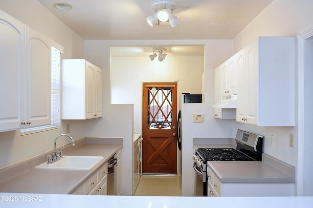 2422 E Drachman St, Tucson, AZ 85719 - kitchen featuring stainless steel range with gas stovetop, a sink, under cabinet range hood, white cabinets, and light countertops