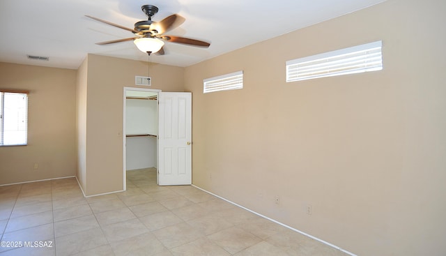 2422 E Drachman St, Tucson, AZ 85719 - unfurnished bedroom featuring a spacious closet, a closet, ceiling fan, and baseboards