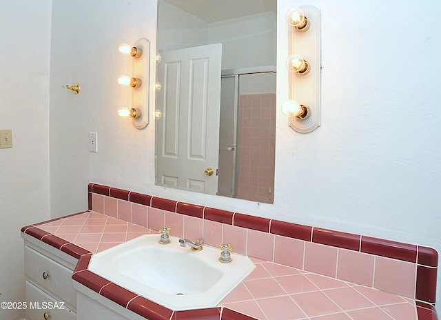 2422 E Drachman St, Tucson, AZ 85719 - bathroom featuring decorative backsplash, vanity, and a shower with door