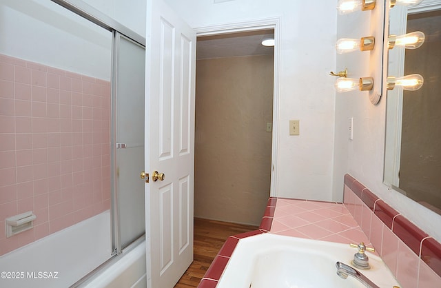 2422 E Drachman St, Tucson, AZ 85719 - full bath featuring wood finished floors and bath / shower combo with glass door