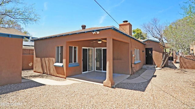2422 E Drachman St, Tucson, AZ 85719 - back of property featuring ceiling fan, a chimney, stucco siding, and a patio