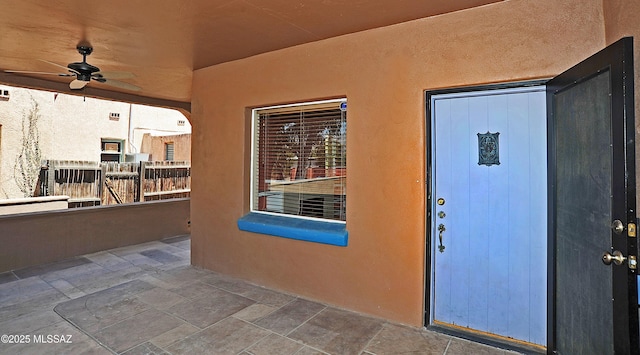 2422 E Drachman St, Tucson, AZ 85719 - doorway to property featuring a ceiling fan and stucco siding