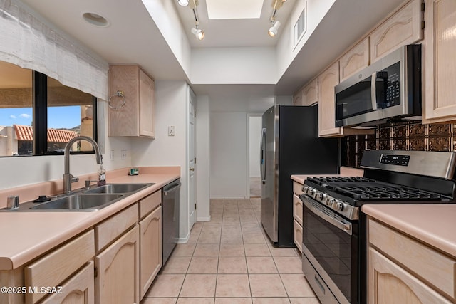 242 E Calle Turquesa, Tucson, AZ 85704 - kitchen featuring stainless steel appliances, a sink, light brown cabinetry, and light tile patterned floors