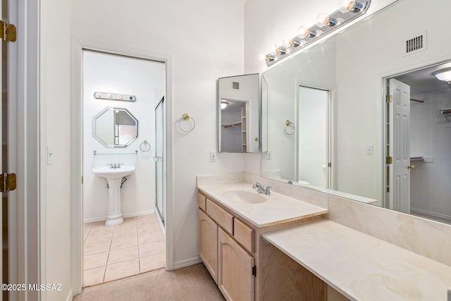 242 E Calle Turquesa, Tucson, AZ 85704 - full bathroom featuring a sink, a shower stall, tile patterned floors, and baseboards