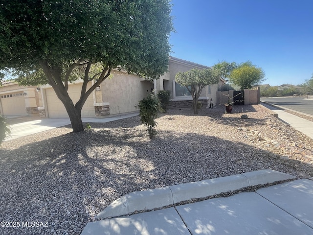 15808 S Via Cayetano, Sahuarita, AZ 85629 - view of side of property featuring stucco siding, a garage, and concrete driveway