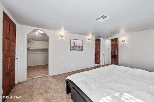 966 N Richey Blvd, Tucson, AZ 85716 - bedroom with a closet, arched walkways, baseboards, and a spacious closet
