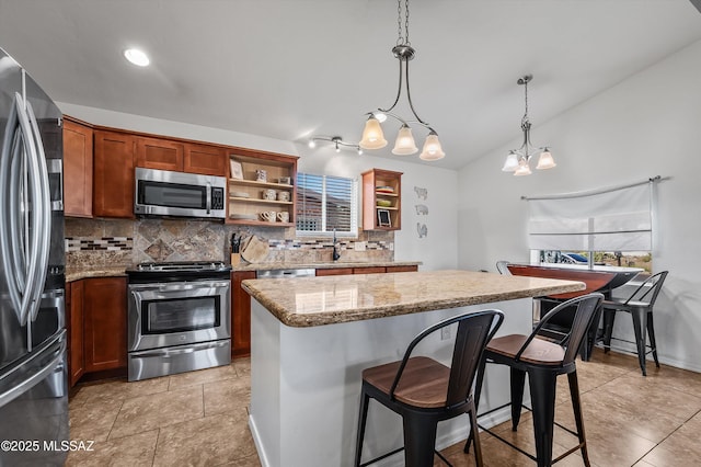 966 N Richey Blvd, Tucson, AZ 85716 - kitchen featuring appliances with stainless steel finishes, open shelves, decorative backsplash, a kitchen island, and lofted ceiling