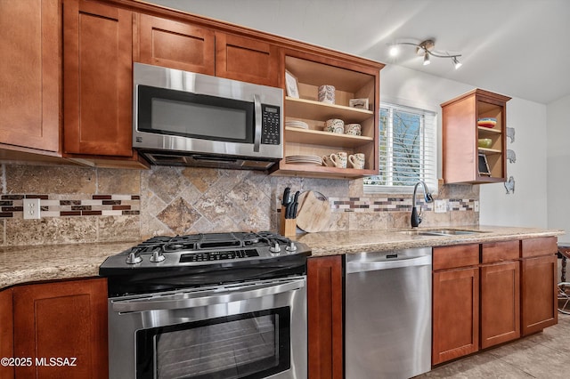 966 N Richey Blvd, Tucson, AZ 85716 - kitchen featuring appliances with stainless steel finishes, open shelves, a sink, brown cabinetry, and light stone countertops