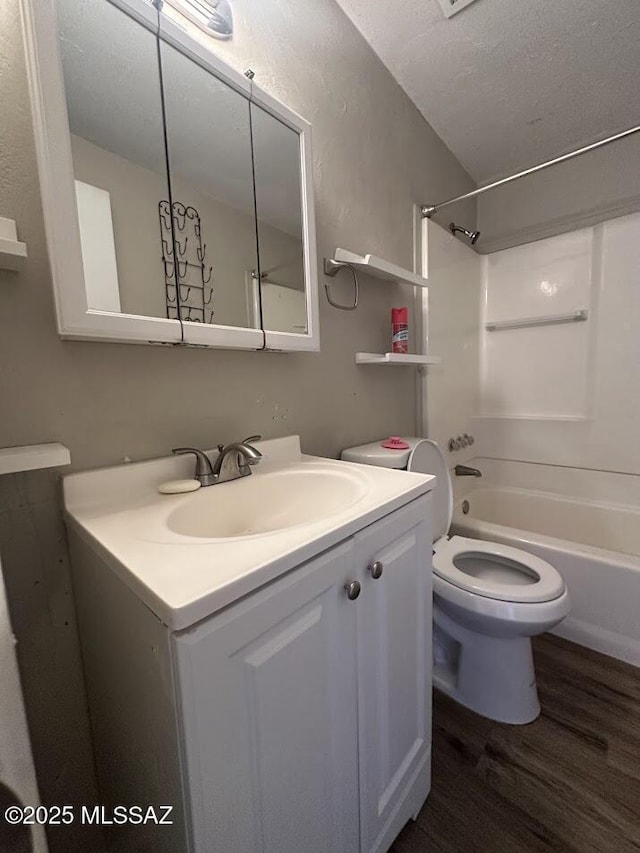3958 N Pomona Rd, Tucson, AZ 85705 - bathroom featuring wood finished floors, vanity, shower / bathtub combination, and toilet