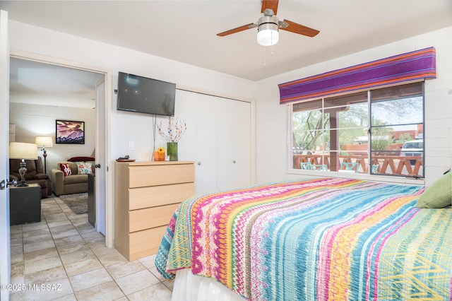 233 S Paseo Tierra Unit D, Green Valley, AZ 85614 - bedroom with a closet, a ceiling fan, and light tile patterned flooring