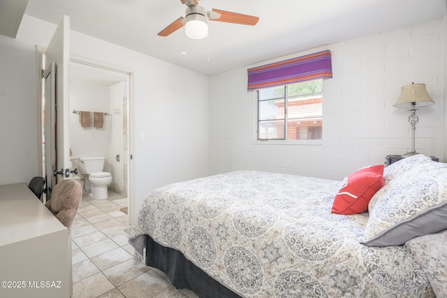 233 S Paseo Tierra Unit D, Green Valley, AZ 85614 - bedroom featuring light tile patterned floors, ensuite bath, concrete block wall, and ceiling fan