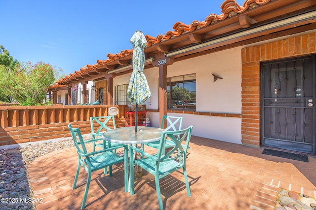 233 S Paseo Tierra Unit D, Green Valley, AZ 85614 - wooden deck with outdoor dining area and a patio area