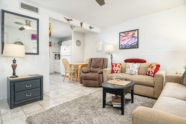 233 S Paseo Tierra Unit D, Green Valley, AZ 85614 - living area with a ceiling fan, light tile patterned flooring, and baseboards
